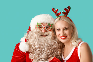 Wall Mural - Santa with MRS Claus in Christmas deer horns and glasses on blue background