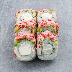 Wall Mural - Set of maki sushi rolls with shrimp, avocado, cream cheese and red flying fish caviar.