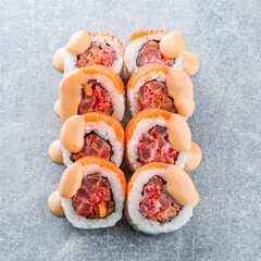 Wall Mural - Japanese food maki sushi rolls with tuna, salmon, flying fish caviar and sauce.