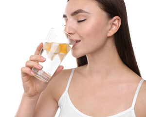 Poster - Woman drinking water with lemon on white background, closeup