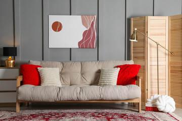 Sticker - Wooden folding screen, comfortable sofa with pillows and lamp in room