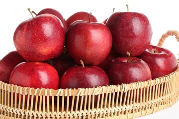 Wall Mural - Fresh ripe red apples in wicker tray isolated on white