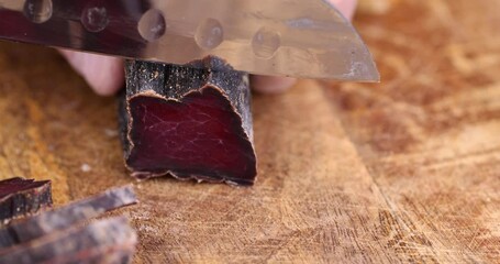 Wall Mural - beef jerky cut into pieces on the table, salted beef sliced for serving