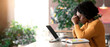 © Prostock-studio - Exhausted african american girl sitting in cafe, looking for job online, using laptop, empty space