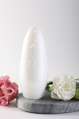 Wall Mural - Roll-on deodorant and beautiful eustoma flowers on white background