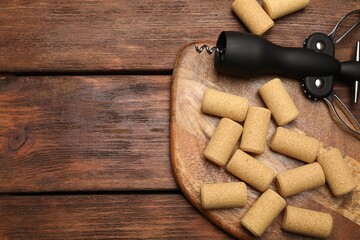 Poster - Wing corkscrew and corks on wooden table, flat lay. Space for text