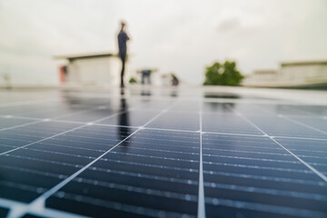 Wall Mural - a worker installs or maintains solar panels on a rooftop. the image highlights renewable energy tech