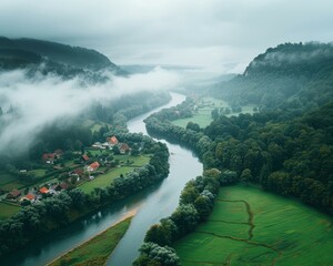 Sticker - A winding river flows through a valley shrouded in mist. AI.