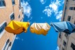 © Sanchai - Bright laundry hanging between two buildings, fluttering in the breeze