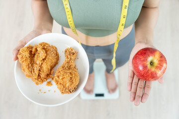 slim body asian women choose healthy foods, dieting female choose red apple for diet. Good healthy food. weight lose, balance, control, reduce fat, low calories, routines, exercise, body shape.