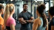 © Oulaphone - A fit coach engages with a group of women in a gym, fostering motivation and teamwork in a supportive fitness environment.
