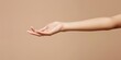 © Maftuh - A graceful hand reaches out against a soft, neutral background, conveying openness and invitation in a minimalist setting