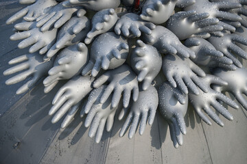 Abstract composition of inflated rubber gloves with water droplets creating unique artistic pattern