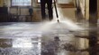 © 69 - High-pressure water sprayer removing grime from floors, ensuring cleanliness in an industrial environment.
