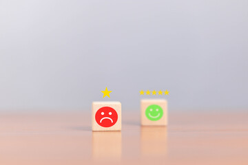 
Businessman selects unhappy angry face from emotion block. Customer feedback, bad experience, survey, rating service, evaluation, emotion.