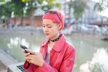 Traveler girl using mobile phone on street in city Fashion gen z asian woman .Technology connection outdoor communication generation z modern lifestyle