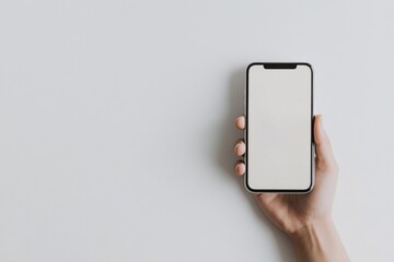 Woman holding smartphone with blank screen on white background