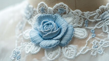 Wall Mural - A beautiful blue rose is embroidered on the neckline of a garment. This vintage Victorian-style design features delicate floral details and is perfect for adding a touch of elegance to any textile.