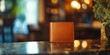 © Ali - Brown leather wallet on a shiny surface.