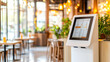 © Studios - Modern design white glossy self-service kiosk as the focal point in a restaurant, vibrant lighting, digital menu display on the kiosk, clean and minimalist background