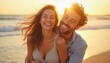 © kotlyarn - A happy couple enjoying a moment together on the beach at sunset. The golden light adds warmth and joy to the scene.