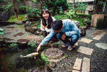 Young japanese couple spending time in their house