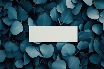 Poster - A flat rectangular space on a backdrop of vibrant blue-green leaves.