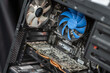 © Anat art - Inside a computer case showcasing components like a graphics card, cooling fan, and intricate circuitry during home assembly