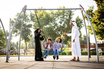 Cinematic image of a family playing at the playground