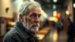 © okaro - Elderly Man Sitting Alone In Dimly Lit Public Space