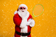 © deagreez - Portrait of his he nice attractive amazed stunned wondered funny Santa enjoying playing badminton team cup contest workout isolated bright vivid shine vibrant yellow color background