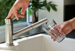 © TatjanaMeininger - Close up of male hands pouring tap water into a glass in the kitchen