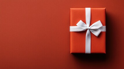 Classic red gift box with a white ribbon, perfect for holiday celebrations and customizable text space.