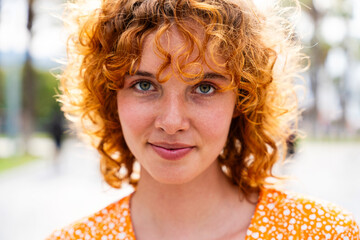 Portrait of cheerful and beautiful young girl with red hair