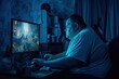 © Ruslan Gilmanshin - Overweight man sitting at desk playing video game. Male with bad habits is sitting in front of computer