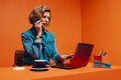 © Jacob Lund - Entrepreneur woman strategizing business plans over the phone while working on laptop