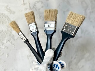 hand with brush. paint brushes in hand on a light background