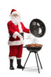 © Ljupco Smokovski - Santa claus grilling meat on a bbq