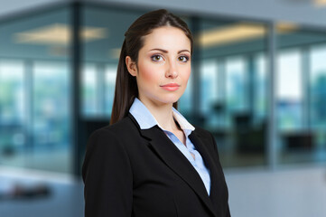 Wall Mural - Confident businesswoman posing in modern office building