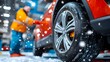 © maesarin - Close up detailed view of snow tires being professionally installed on the wheels of a car in a garage workshop setting
