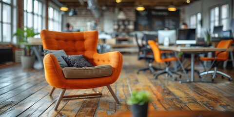 Wall Mural - Bright and modern open-plan office space with focus on a striking orange armchair, surrounded by desks, chairs, and computers, set on a polished wooden floor