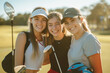 © Ирина Щукина - Three girls are smiling and posing for a picture on a golf course