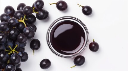 Delectable Display: Top-View of Black Grapes and Grape Molasses in Glass Bowl, Isolated on Crisp Whi