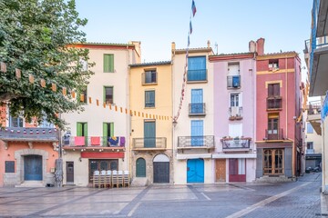 Colorful square with traditional architecture and community atmosphere in the French town of Colliure