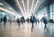 © Mariia - Blurred silhouettes of people at the airport. Spacious room, businessman, business. People in suits rushing to work