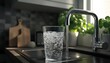 © Anastasiia - Clean water flowing from the kitchen tap into a glass cup in bright sunlight