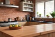 © Sharif54 - A wooden kitchen counter with a brick wall and kitchen appliances in the background.