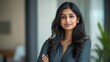 © Johannes - Portrait of a successful business leader indian woman Standing confidently with arms crossed and shows a happy face in the office lightly