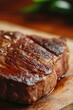 © StockUp - Seared steak resting on a wooden board, showcasing juicy and well-cooked texture.