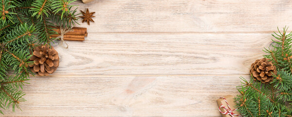 Wall Mural - Christmas background with fir tree and gift box on wooden table. Top view with copy space for your design